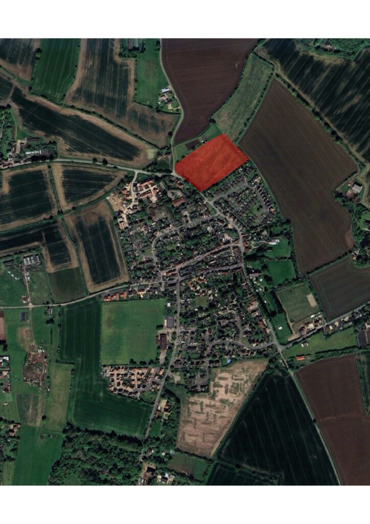 Aerial photo of Mendlesham village showing site for new homes in red